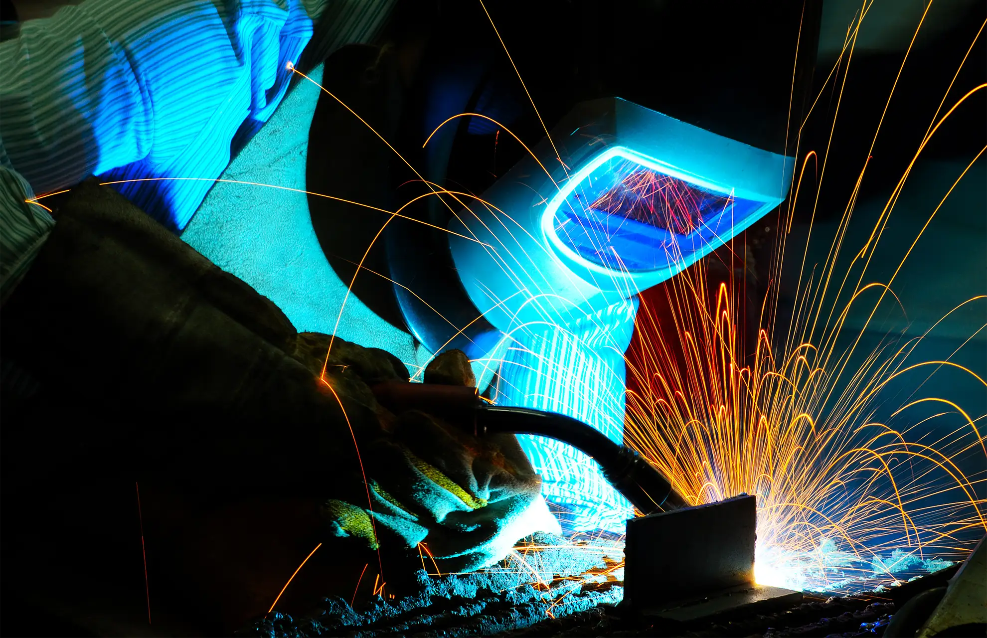 MIG welder producing sparks during metal fabrication services